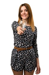 Beautiful young girl holding a bulb