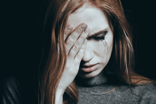 Tears falling down girl's cheek with depression
