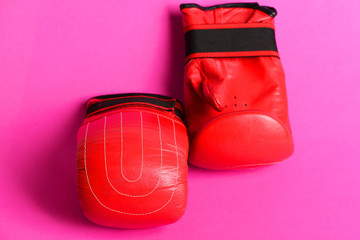 Pair of red gloves for box placed in geometrical pattern
