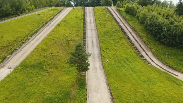 Aerial view Road for a drive test drive, climb up the slope. Simulation of climbing uphill for vehicle testing.Test road in the forest for testing and fine-tuning cars. 4K, aerial footage.