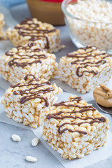 Homemade three ingredients bars: crispy rice, honey and peanut butter, vertical