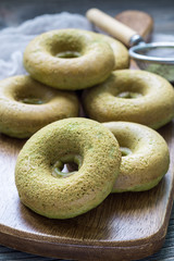 Naklejka premium Freshly baked matcha banana donuts, vertical