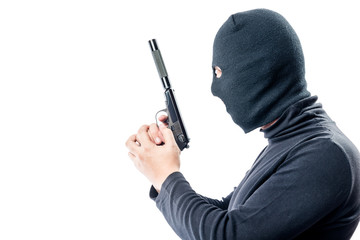 Killer with a gun in black clothes side view on a white background