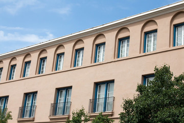 Fototapeta na wymiar Row of windows with arches and window with balcony