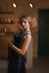 Fototapeta na wymiar Glorious young woman in dress posing on a background of mixed light