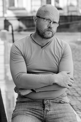 Portrait mature writer hipster man, with red beard walk at the European city  