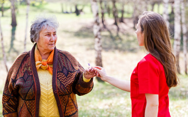 Elderly couple and young caregiver