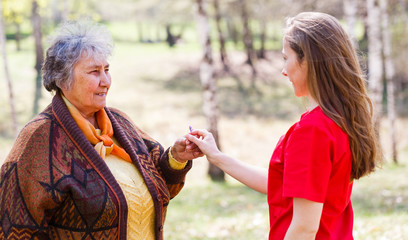 Elderly couple and young caregiver