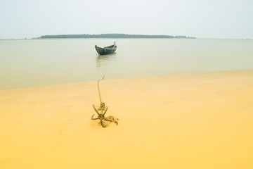 High key image of boat and anchor, Tajpur, West Bengal, India