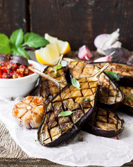 Baked eggplant on a wooden background © yuliiaholovchenko
