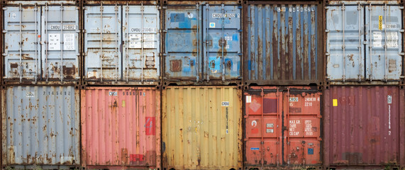 Stack of colourful and rusty containers in the port of Antwerp - Powered by Adobe