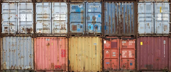 Fototapeten Stack of colourful and rusty containers in the port of Antwerp © Erik_AJV