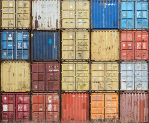 Stack of colourful and rusty containers in the port of Antwerp.