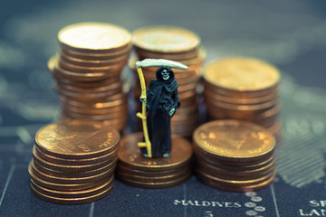 Miniature ghost: Standing on stack of coin. Using as money concept , vintage background.