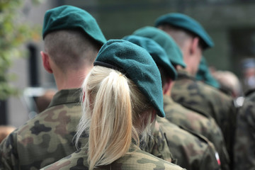 A number of soldiers in uniforms of the Polish army including a woman with bright hair - 165088625