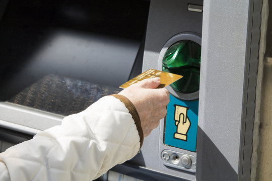 Woman with credit card in bank card reader