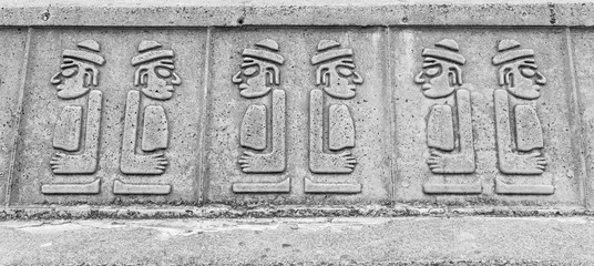 Dol hareubangs statues on wall in Jeju Island