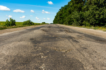 Background texture landscape old road highway with holes in the summer of HDR