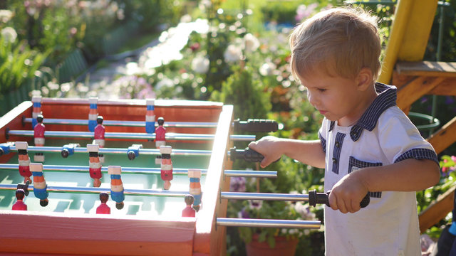 children playing table football outdoors.Fun outdoors