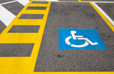 parking space reserved for handicapped shoppers in a retail parking lot.