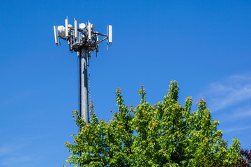 Telecommunications towers are located on the cloud forest detail and beautiful sky background.