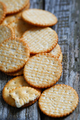 Close-up of a of salted crackers on an old wooden table.