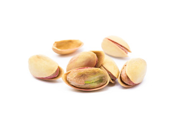 Pile of roasted pistachios isolated on white background