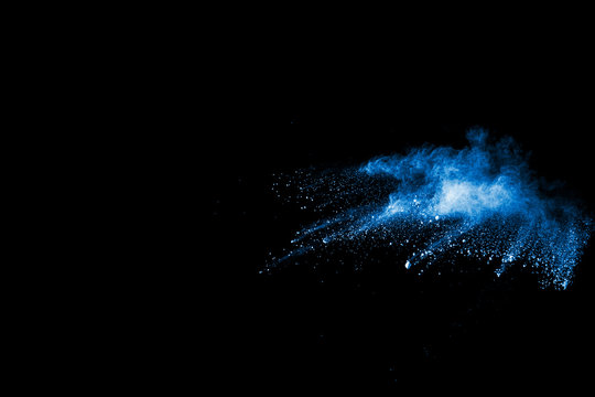 Launched blue  powder, isolated on black background