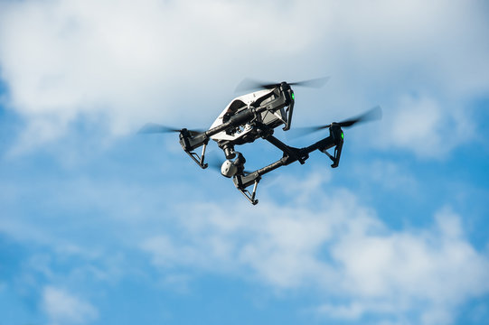 Drone in sky.Selective focus/Drone with camera flies in sky on clouds background