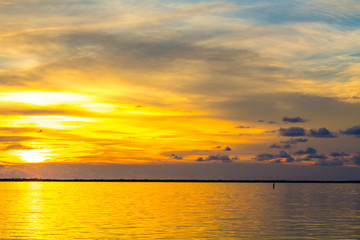 Dusk sunset above Gulf of Mexico ocean in Hudson Florida with orange sky
