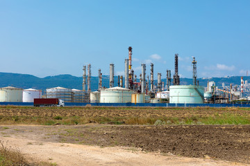 Fototapeta na wymiar Industrial refinery park with mountain in the background
