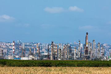 Industrial refinery plant with city in the background