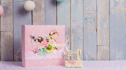 a photo album in the style of shabby chic on a blue background.