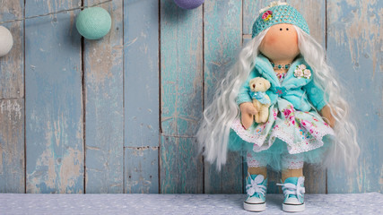 tilde doll on a blue background of the boards with.