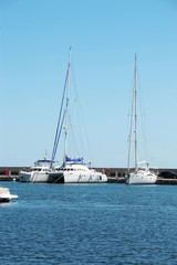 Fototapeta na wymiar Three white yacht on the dock in the Bay on the black sea in Bulgaria in the resort