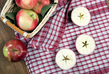 Still life of many apples on a napkin in the basket on a napkin