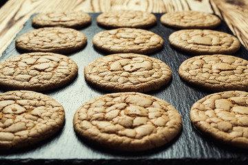Biscuit sweet cookie background. Domestic stacked butter biscuit pattern concept,close up macro.Homemade cookies on wooden table.Cereal biscuits with the sesame,peanuts,sunflower and amaranth.