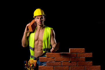 fit shirtless worker with tools