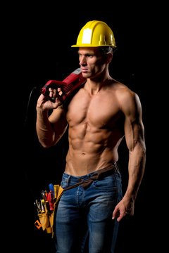 fit shirtless worker with tools