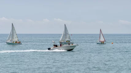 Fotobehang Rest on sea. Motor boat, boats with sail. Outdoor sea sporting activity © Natalia