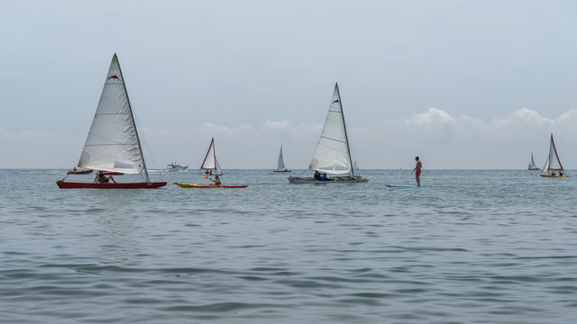 Rest on sea. Sea kayak, boats with sail, catamaran, stand up paddler. Outdoor sea sporting activity