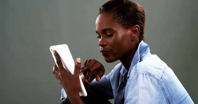 Androgynous man using digital tablet