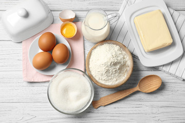 Ingredients for butter cake on wooden table