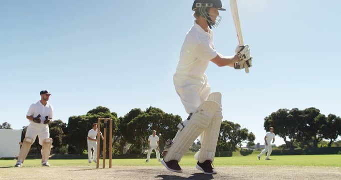 Batsman playing a defensive stroke during cricket match