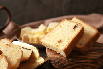 Delicious sliced butter cake with raisins on table, closeup