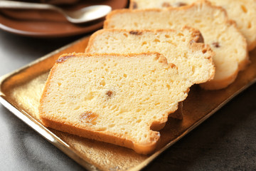 Tray with delicious sliced butter cake on  table