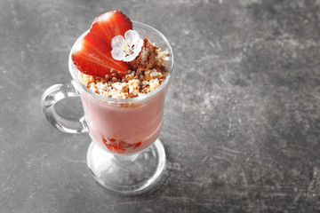 Delicious yogurt parfait with strawberry in glass on table