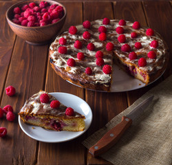 Summer pie with raspberries on a dark wooden background