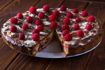 Summer pie with raspberries on a dark wooden background