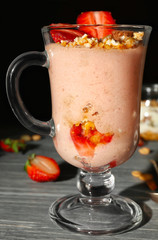 Delicious yogurt parfait with strawberry in glass on table